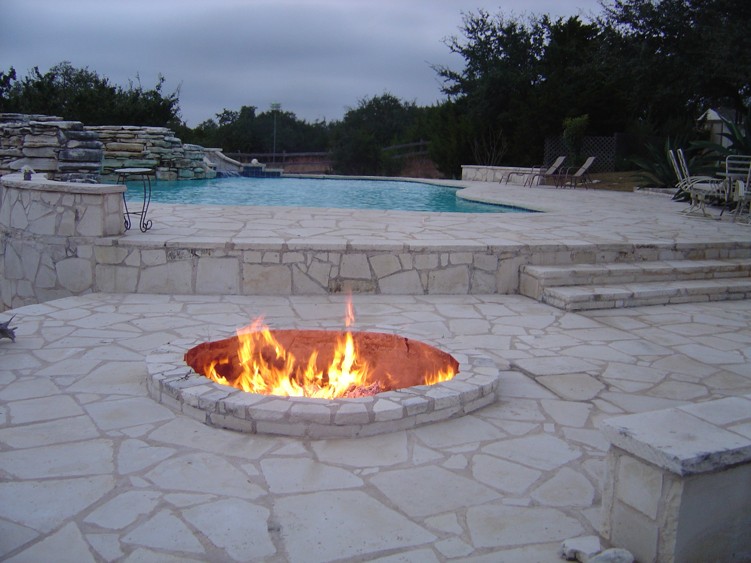 Ranch Setting Pool with Stone Deck and Fire Pit